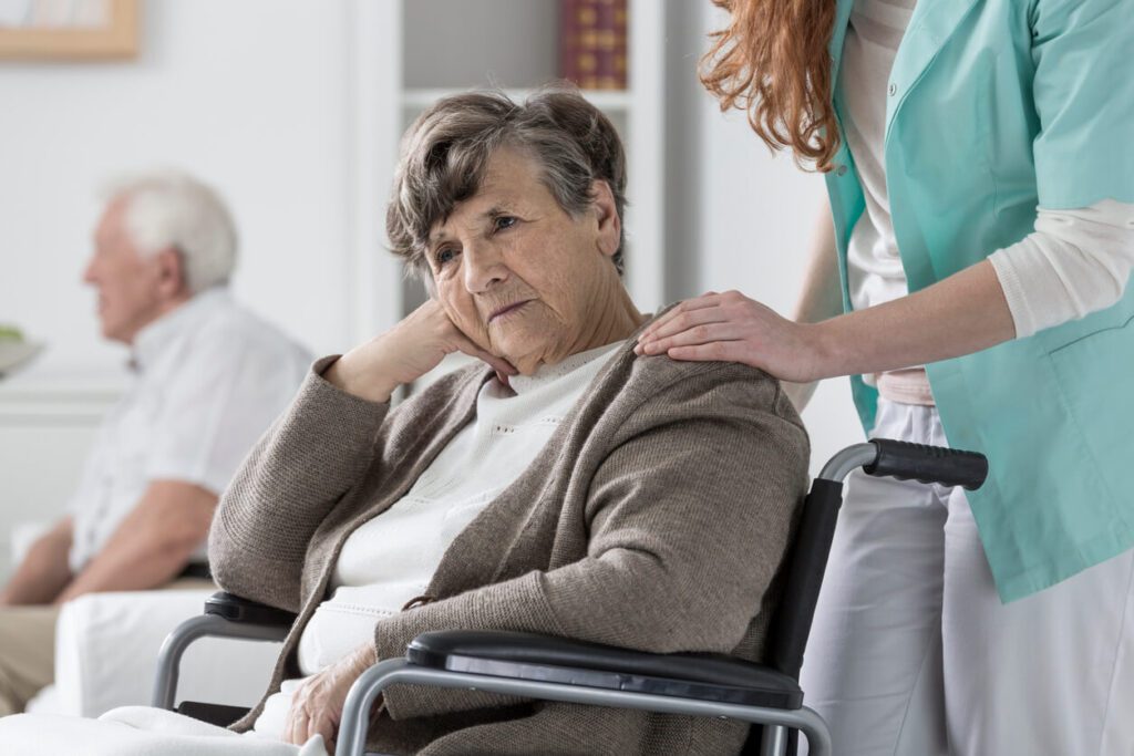 elderly woman sad in wheel chair